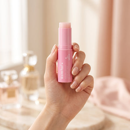 danchel pink glow balm stick held in hand