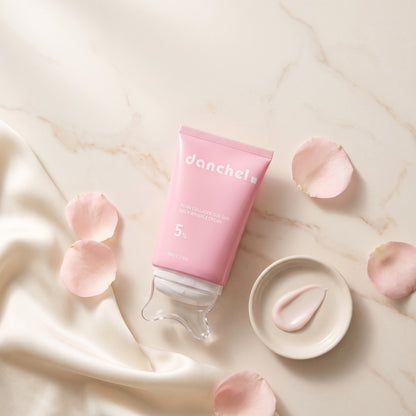 danchel neck cream flat-lay on marble with petals