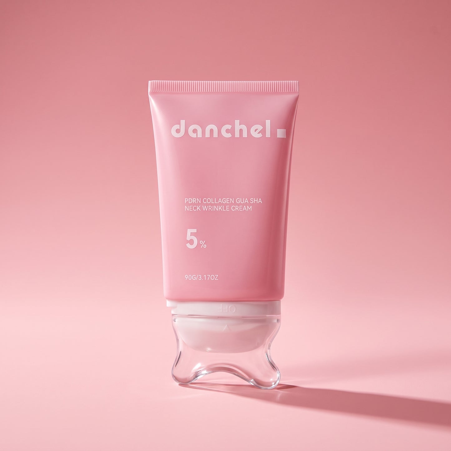 danchel neck cream on a pink editorial background