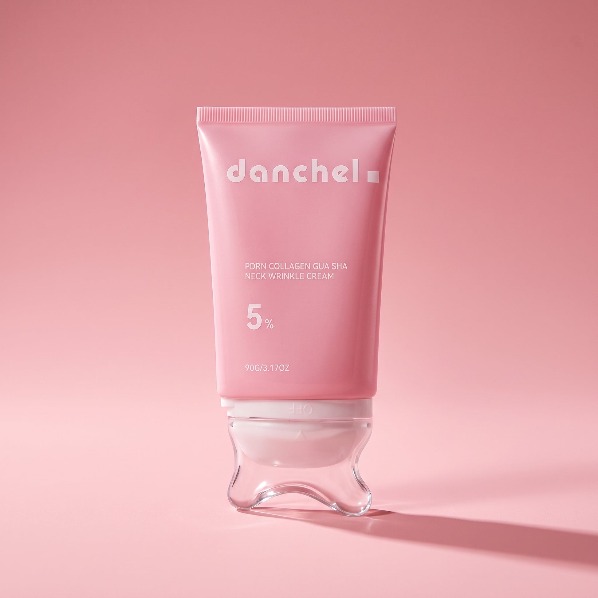 danchel neck cream on a pink editorial background