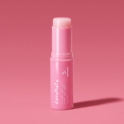 danchel glow balm stick on a pink editorial background